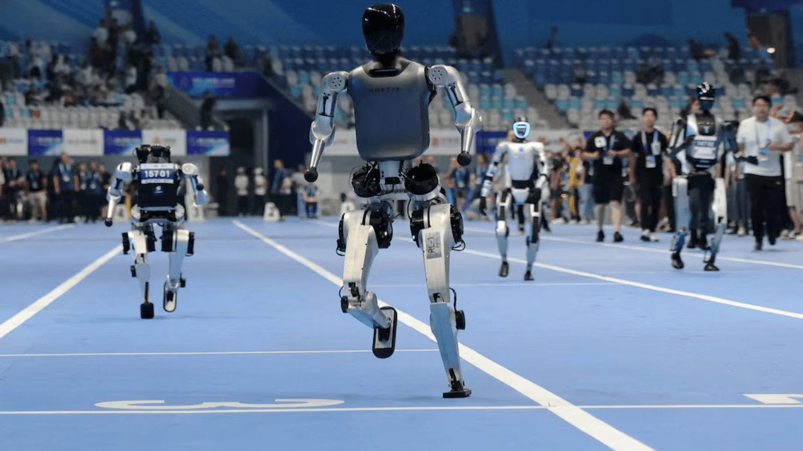 Humanoid robots take part in a test 100m run ahead of the opening ceremony of the inaugural World Humanoid Robot Games, at National Speed Skating Oval, in Beijing, China, August 14, 2025. (Image Source: Reuters)