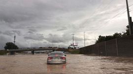 Cars struggle through waterlogged roads on eastbound lanes of US Interstate 24, in Chattanooga, Tennessee flood