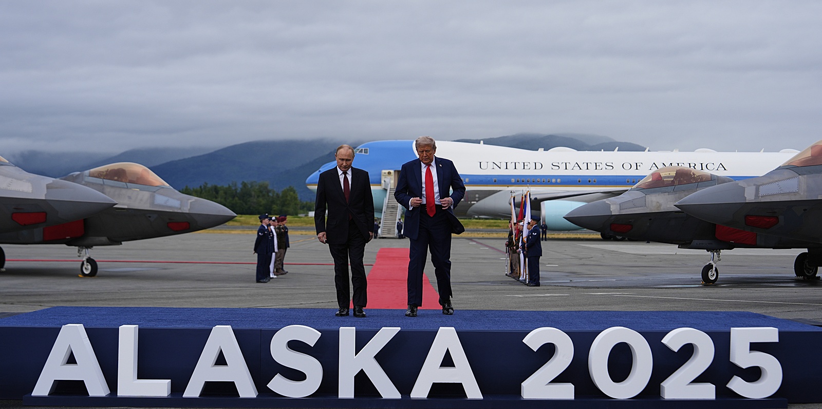President Donald Trump walks onto a stage with Russia's President Vladimir Putin in Alaska on Friday