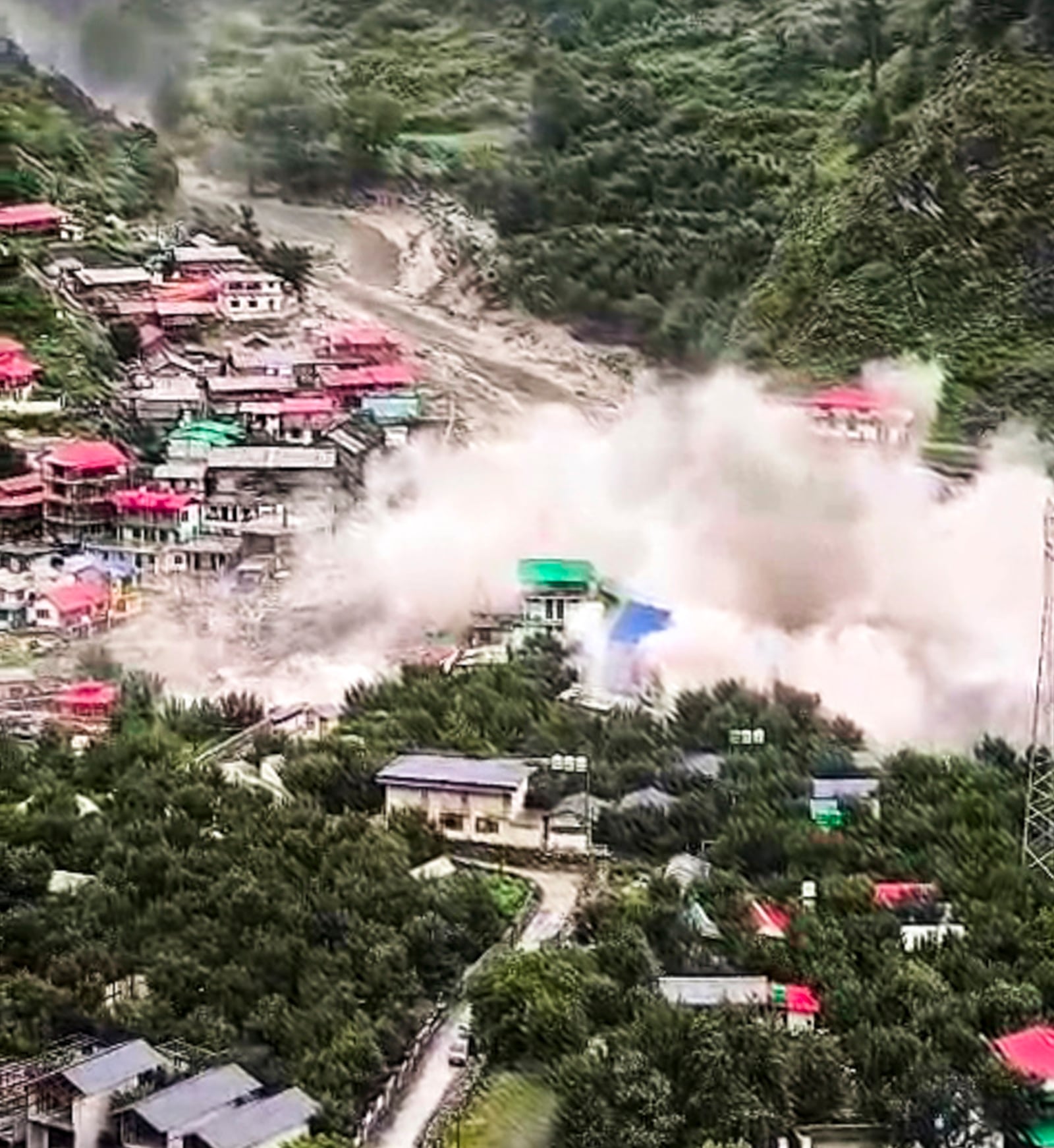 Houses being swept away in a flash flood at Dharali, in Uttarkashi district