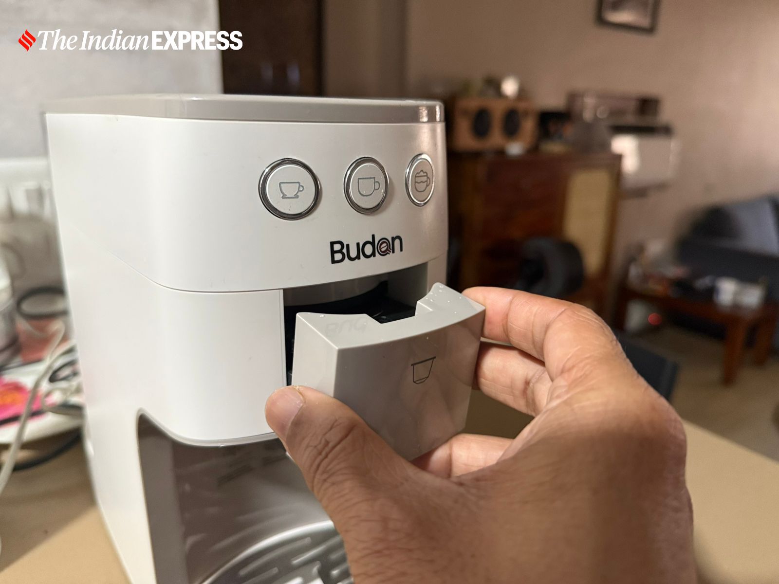 Inserting the coffee powder attachment into the Budan One Touch Coffee Machine. (Image: Nandagopal Rajan/The Indian Express)