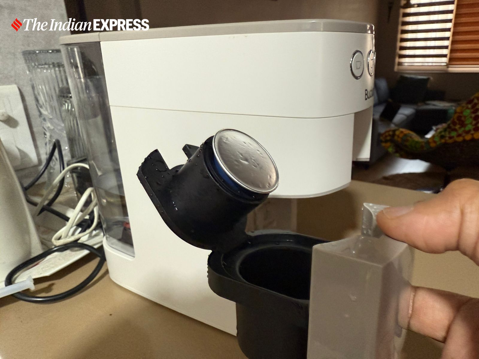 Loading a coffee pod into the Budan One Touch Coffee Machine for a quick brew. (Image: Nandagopal Rajan/The Indian Express)