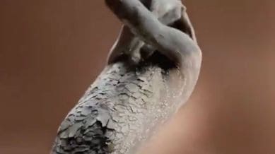 The advertisement, which aired in June, showed a Black model with red scratch marks on her skin and another with a cracked, clay-like texture. (Screengrab from video shared by @JamesEsses/X)