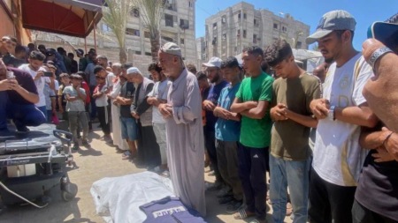 In this family handout photo, Riyad Dagga, center, and other relatives and friends pray over the body of his daughter, freelance journalist Mariam Dagga, 33, during her funeral after she was killed in a double Israeli strike on Nasser Hospital in Khan Younis, southern Gaza Strip (AP/PTI)