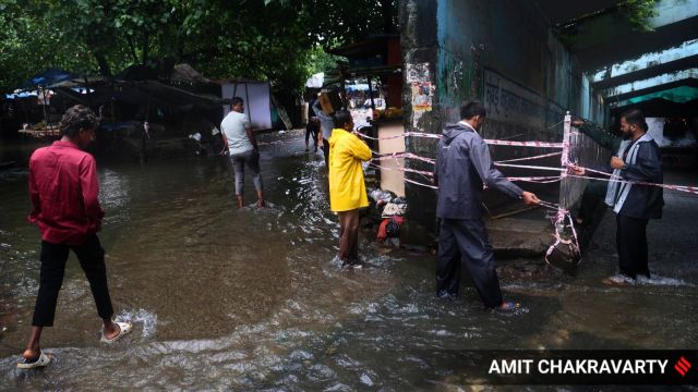 Water levels have receded at Maharashtra Nagar in Mumbai 's Mankhurd (East), but remnants of the severe waterlogging from the past two days persist. (Express Photo by Amit Chakravarty)
