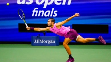 Carlos Alcaraz, of Spain, returns a shot to Jannik Sinner, of Italy, during the men's singles final of the U.S. Open tennis championships in New York. (AP Photo)