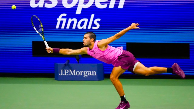 Carlos Alcaraz, of Spain, returns a shot to Jannik Sinner, of Italy, during the men's singles final of the U.S. Open tennis championships in New York. (AP Photo)