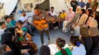 Music teacher Ahmed Abu Amsha performs for children and adults in Gaza (Photo: Instagram/@ahmedmuin_abuamsha)