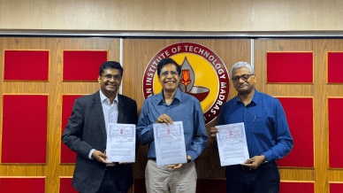 Bhuvan Anandakrishnan, Vice President, Caterpillar Inc, Prof V Kamakoti, Director, IIT Madras & Prof Manu Santhanam, Dean (ICSR), IIT Madras with the MoU (L-R) (Image via IIT-M)