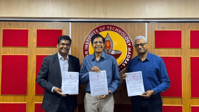 Bhuvan Anandakrishnan, Vice President, Caterpillar Inc, Prof V Kamakoti, Director, IIT Madras & Prof Manu Santhanam, Dean (ICSR), IIT Madras with the MoU (L-R) (Image via IIT-M)