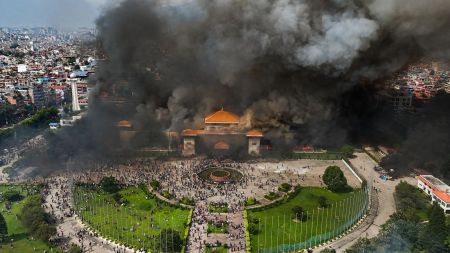 Protesters celebrate at the Singha Durbar, the seat of Nepal's government's various ministries and offices after it was set on fire during a protest against social media ban and corruption in Kathmandu, Nepal, Tuesday, Sept. 9, 2025. AP/PTI