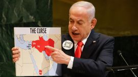 Israeli Prime Minister Benjamin Netanyahu holds up a map while speaking at the 80th session of the United Nations General Assembly, Friday, Sept. 26, 2025, at U.N. headquarters. (AP Photo/Stefan Jeremiah)