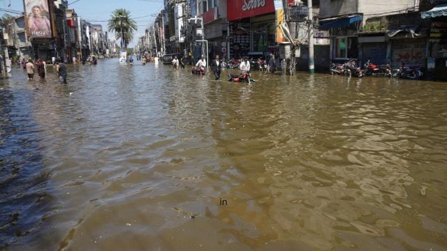 Residents navigate through a flooded road following by heavy rains, in Gujrat, Pakistan, Thursday, Sept. 4, 2025. (AP Photo/A. Rizvi)