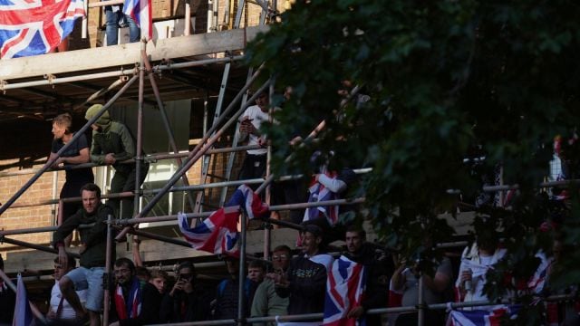 People attend the Tommy Robinson-led Unite the Kingdom march and rally near Westminster, London, Saturday Sept. 13, 2025. (AP Photo)