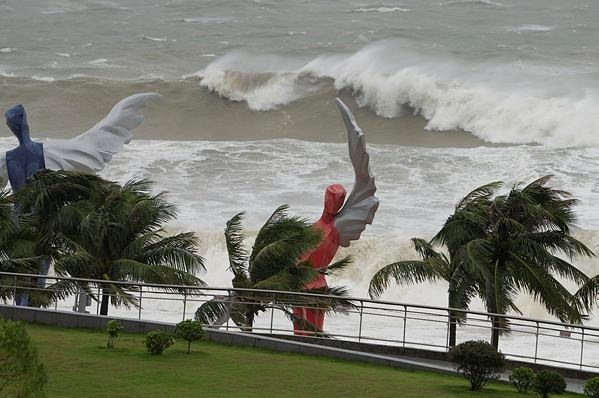Waves crash onto a beach near giant sculptures in Shenzhen in southern China's Guangdong province on Wednesday