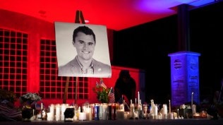 A photo of Charlie Kirk, the CEO and co-founder of Turning Point USA who was shot and killed, stands at his vigil,
