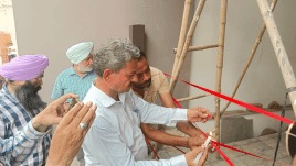 Employees of Naya Gaon Municipal Council sealing an illegal building. Express