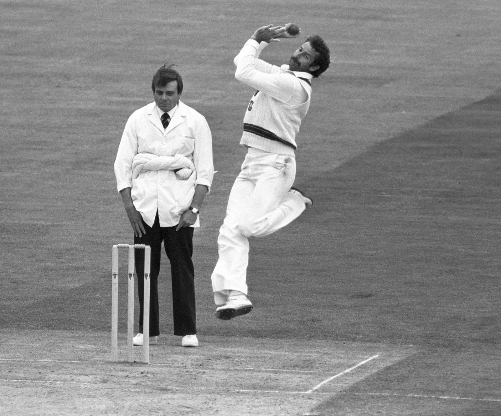 Dickie Bird looks on as Australia great Dennis Lillee bowls. (AP Photo)