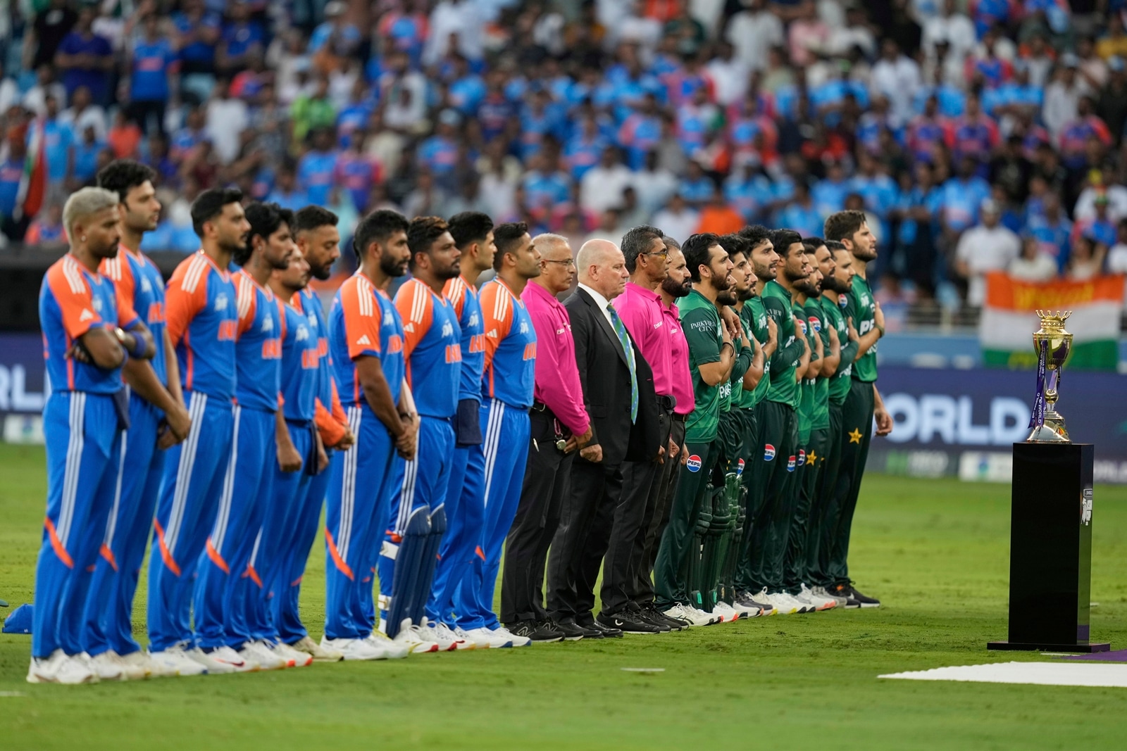 Pakistan players, right, stand for their national anthem before the start of the Asia Cup cricket match between India and Pakistan at Dubai International Cricket Stadium in Dubai, United Arab Emirates, Sunday, Sept. 14, 2025. (AP Photo/Altaf Qadri)