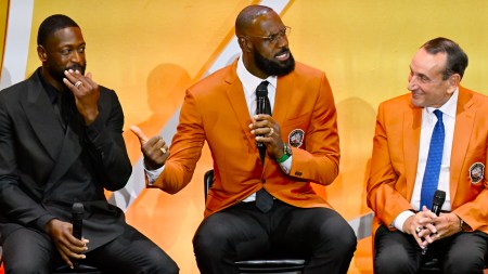 LeBron James, center, shares a light moment with Dwyane Wade, left, and Mike Krzyzewski, during the enshrinement for the 2008 USA Basketball Men's National Team in the Basketball Hall of Fame, Saturday, Sept. 6, 2025, in Springfield, Mass. (AP Photo)