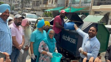 Mayor Amarjit Singh Jeeti Sidhu (with a blue dustbin in hand) during an awareness campaign in ward no. 10 in Mohali on Sunday. Express