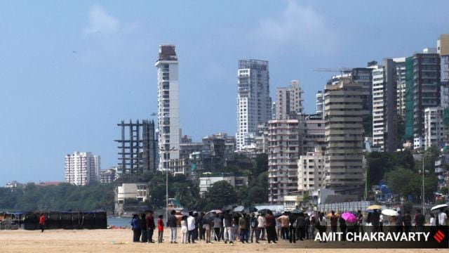 At Girgaon Chowpatty on Thursday, people are using umbrellas to shield themselves from the rising heat. With rain having stopped for the past few days, temperatures have climbed. However, Mumbai is expected to see a return of rains over the weekend, as the Meteorological Department has issued a fresh alert for the city and nearby districts from Saturday to Sunday. Express Photo by Amit Chakravarty 11-09-25 , Mumbai