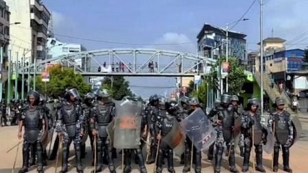 Security personnel with shields stand guard during a protest by youth against the Nepal government's decision to ban social media sites, in Kathmandu