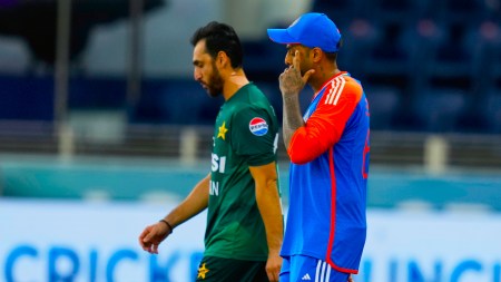 India's captain Suryakumar Yadav, right, and Pakistan's captain Salman Agha walk onto the field before the start of the Asia Cup cricket match between India and Pakistan at Dubai International Cricket Stadium. (AP Photo)