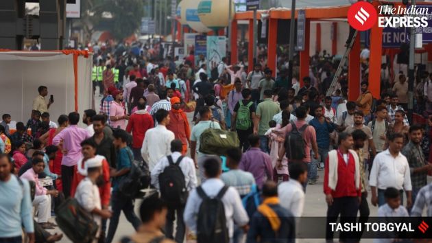 Passengers navigate through the crowded platforms at Newd Delhi railway station for Chhath Puja