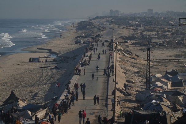 Displaced Palestinians walk along the coastal road near Wadi Gaza in the central Gaza Strip, Friday, Oct. 10, 2025, after Israel and Hamas have agreed to a pause in their war and the release of the remaining hostages. (AP Photo/Abdel Kareem Hana)