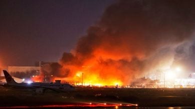Fire and smoke are visible in the cargo area of Hazrat Shahjalal International Airport in Dhaka, Bangladesh, Saturday, Oct. 18, 2025. (AP Photo/Rajib Dhar)