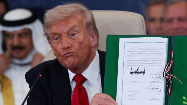 President Donald Trump holds a signed document during a summit to support ending the more than two-year Israel-Hamas war in Gaza after a breakthrough ceasefire deal, Monday, Oct. 13, 2025, in Sharm El Sheikh, Egypt.