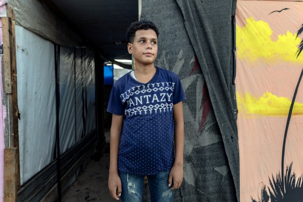 Mahmour Aby Shahma, 14, in the camp where he lives in southern Gaza in September 2025. He has been out of school for more than two years. (Saher Alghorra/The New York Times)