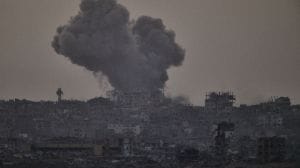 Smoke rises amid buildings, that were destroyed during the Israeli ground and air operations, following an Israeli military strike in the northern Gaza Strip, as seen from southern Israel, Friday, Oct. 3, 2025. (AP Photo/Leo Correa)