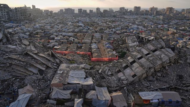 A tent camp for displaced Palestinians stretches among the ruins of buildings destroyed by Israeli bombardments in west Gaza City, Saturday, June 21, 2025. (AP Photo/Jehad Alshrafi, File)