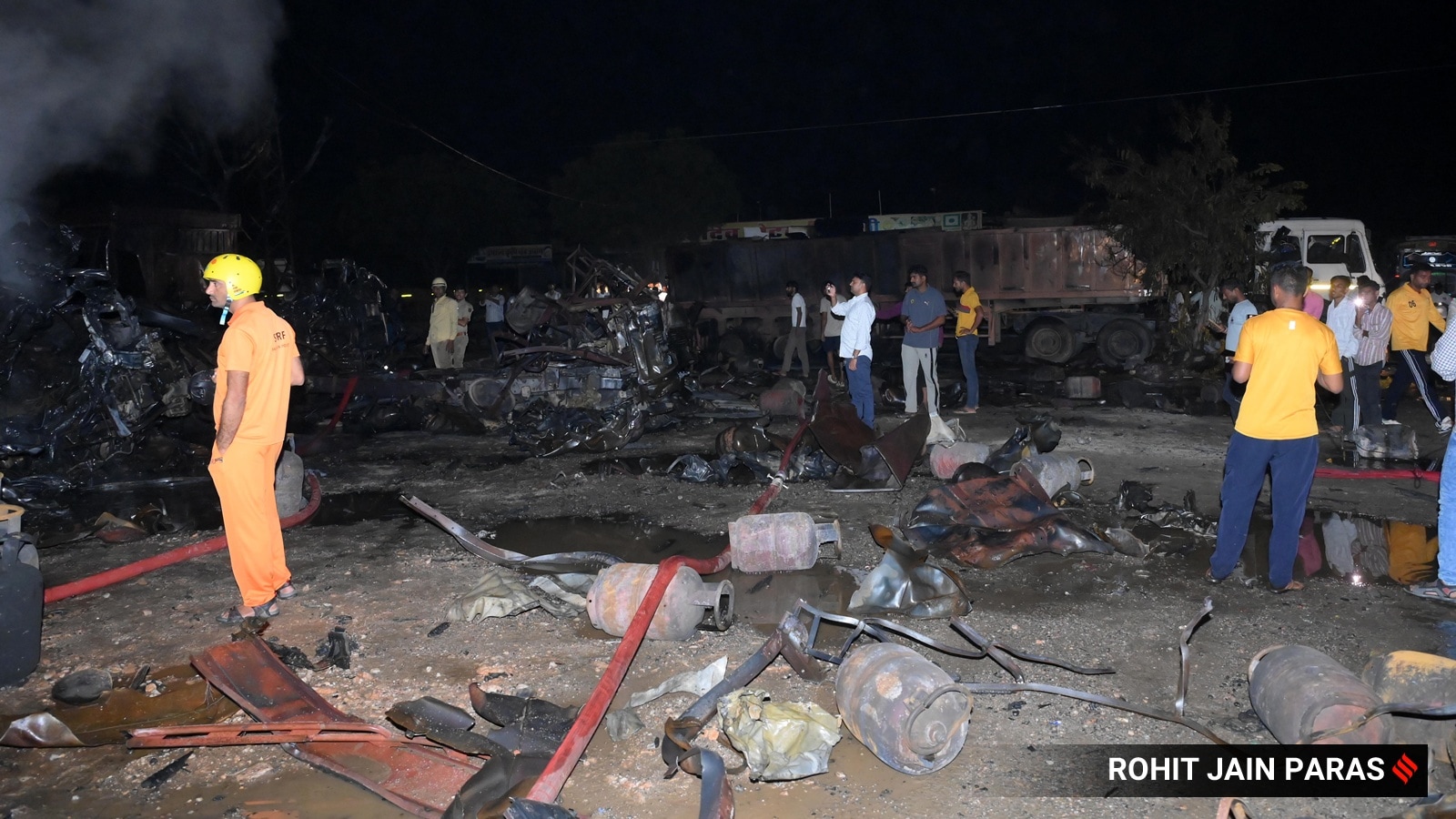 Fire fighters try to douse the flames after a truck carrying gas cylinders caught fire following an accident on the Jaipur-Ajmer Highway near Dudu town around midnight in Jaipur on Wednesday
