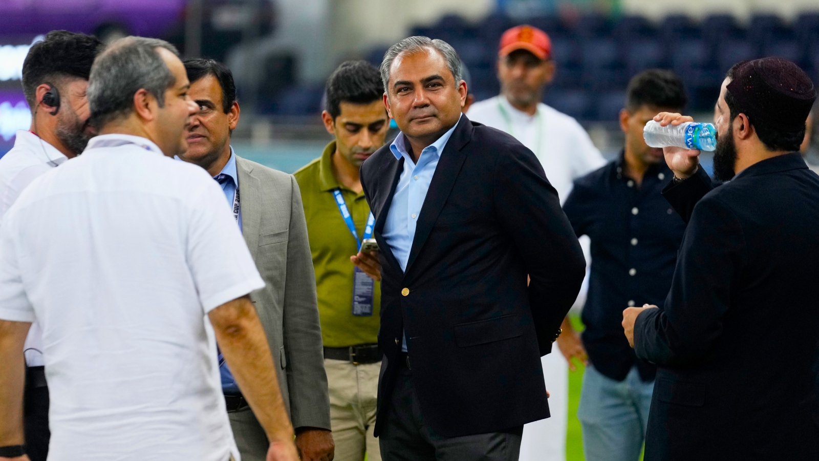 Pakistan's Minister of Interior and President of the Asian Cricket Council Mohsin Naqvi, center, stands with officials on the field after India won the Asia Cup cricket final against Pakistan at Dubai International Cricket Stadium, United Arab Emirates, Sunday, Sept. 28, 2025. (AP Photo)