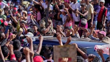 Members of the CAPSAT military unit are cheered by protesters as they arrive to address a crowd, announcing plans to take on the government and dissolve the Senate and the electoral commission (CENI) in Antananarivo, Madagascar, Tuesday, Oct. 14, 2025. (AP Photo/Brian Inganga)