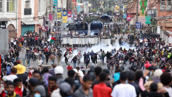 Demonstrators protesting against chronic electricity and water cuts confront riot police in Antananarivo, Madagascar, Tuesday, Sept. 30, 2025. (AP Photo/Mamyrael)