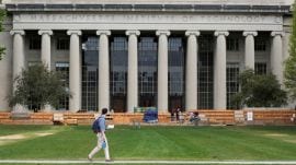 A man walks through Killian Court at the Massachusetts Institute of Technology (MIT) in Cambridge, Massachusetts, U.S. May 13, 2016. REUTERS/Brian Snyder/File Photo