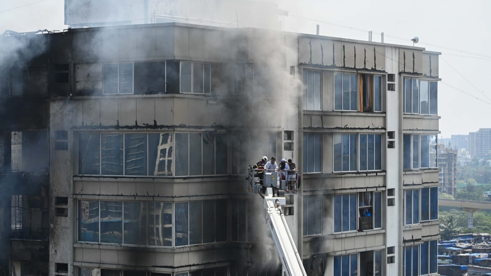 Mumbai building fire: Fire department personnel rescue people from the building in Jogeshwari (Express Photo: Sankhadeep Banerjee)