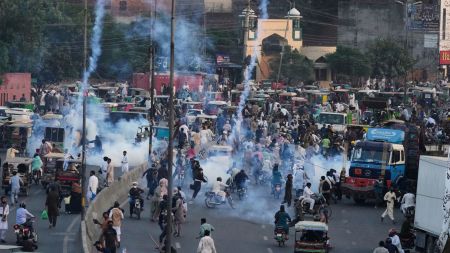 Police fire tear gas shells to disperse supporters of Islamist party 'Tehreek-e-Labbaik Pakistan' during their pro-Palestinian march toward the capital Islamabad, in Lahore, Pakistan, Friday, Oct. 10, 2025. (AP Photo/K.M. Chaudary)