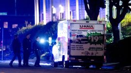 Police officers examine a U-Haul truck involved in a shooting at the entrance to Coast Guard Base Alameda, according to an officer at the scene, Friday, Oct. 24, 2025, in Oakland, Calif. (AP Photo/Noah Berger)