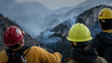 Firefighters near the Eaton fire in the mountains between Altadena and Mount Wilson in Los Angeles County, Jan. 10, 2025. Pollution from fires, intensified by rising temperatures, is on track to become one of America’s deadliest climate disasters. (Loren Elliott/The New York Times)