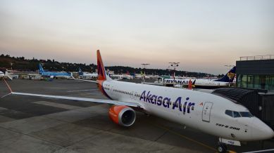 akasa air plane seen parked next to a runway