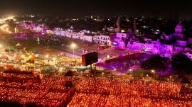 Devotees carry lamps as they pray on the banks of the Sarayu river during Deepotsav celebrations in Ayodhya