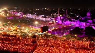 Devotees carry lamps as they pray on the banks of the Sarayu river during Deepotsav celebrations in Ayodhya
