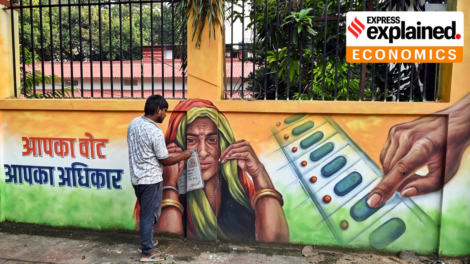 An artist gives final touches to a voter awareness mural on the wall, in Patna, Bihar, on Wednesday. (ANI Photo)