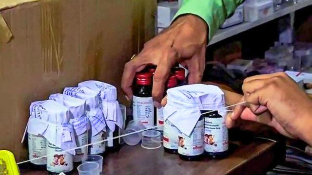 Chhindwara, Oct 5 (ANI): The Drugs Department sealing the Coldrif cough syrup containers after 10 children allegedly die due to consuming it during raid in an Ayush firm, in Chhindwara on Sunday. (ANI Video Grab).
