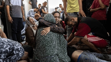 People mourn those killed in an attack on June 30, 2025, on a cafe near Gaza City. More than 67,000, or one in every 34 Gazans, have been killed, according to local health officials. (Saher Alghorra/The New York Times)